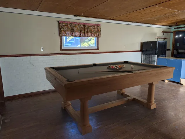 a utility room with furniture and wooden floor