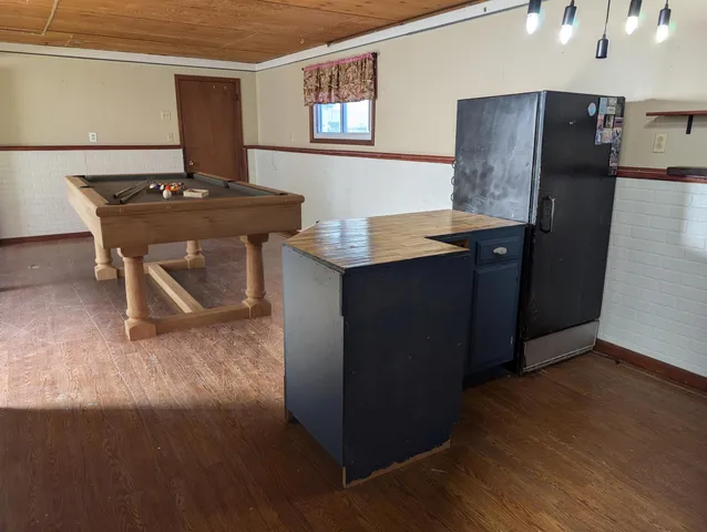 a view of a workspace with furniture and wooden floor