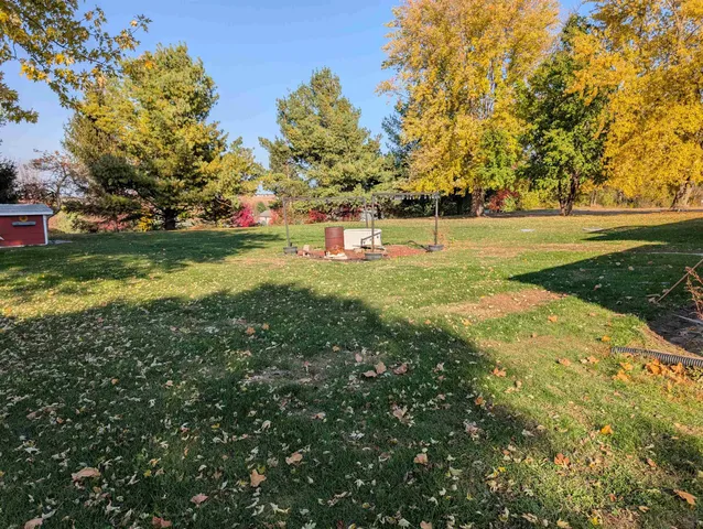 a view of yard with swimming pool and green space