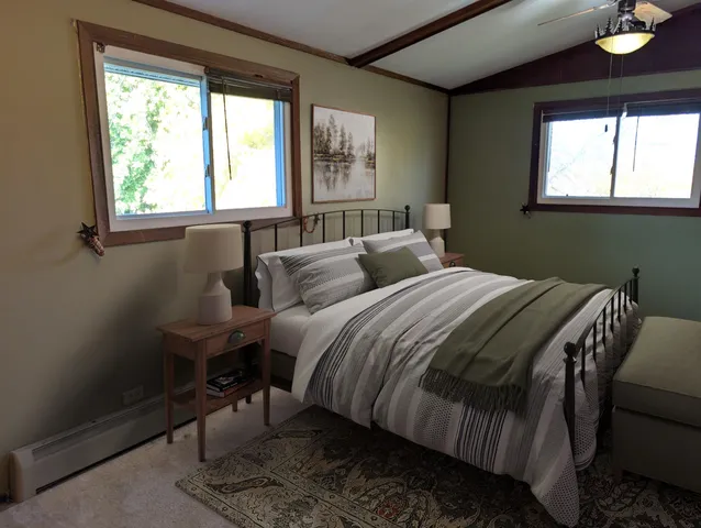 a bedroom with a bed and a window