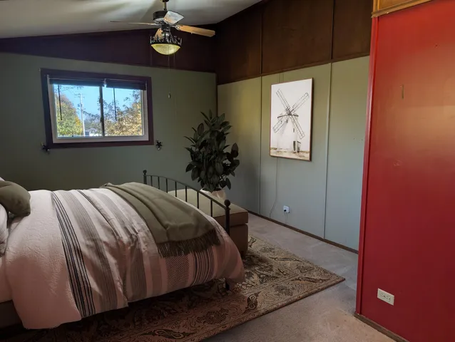 a bedroom with a bed and a window