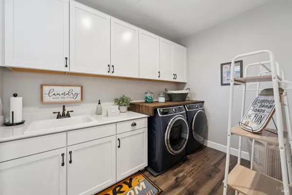 a living room with furniture a flat screen tv and a large window