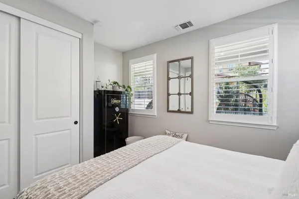a bedroom with a flat screen tv and a bed