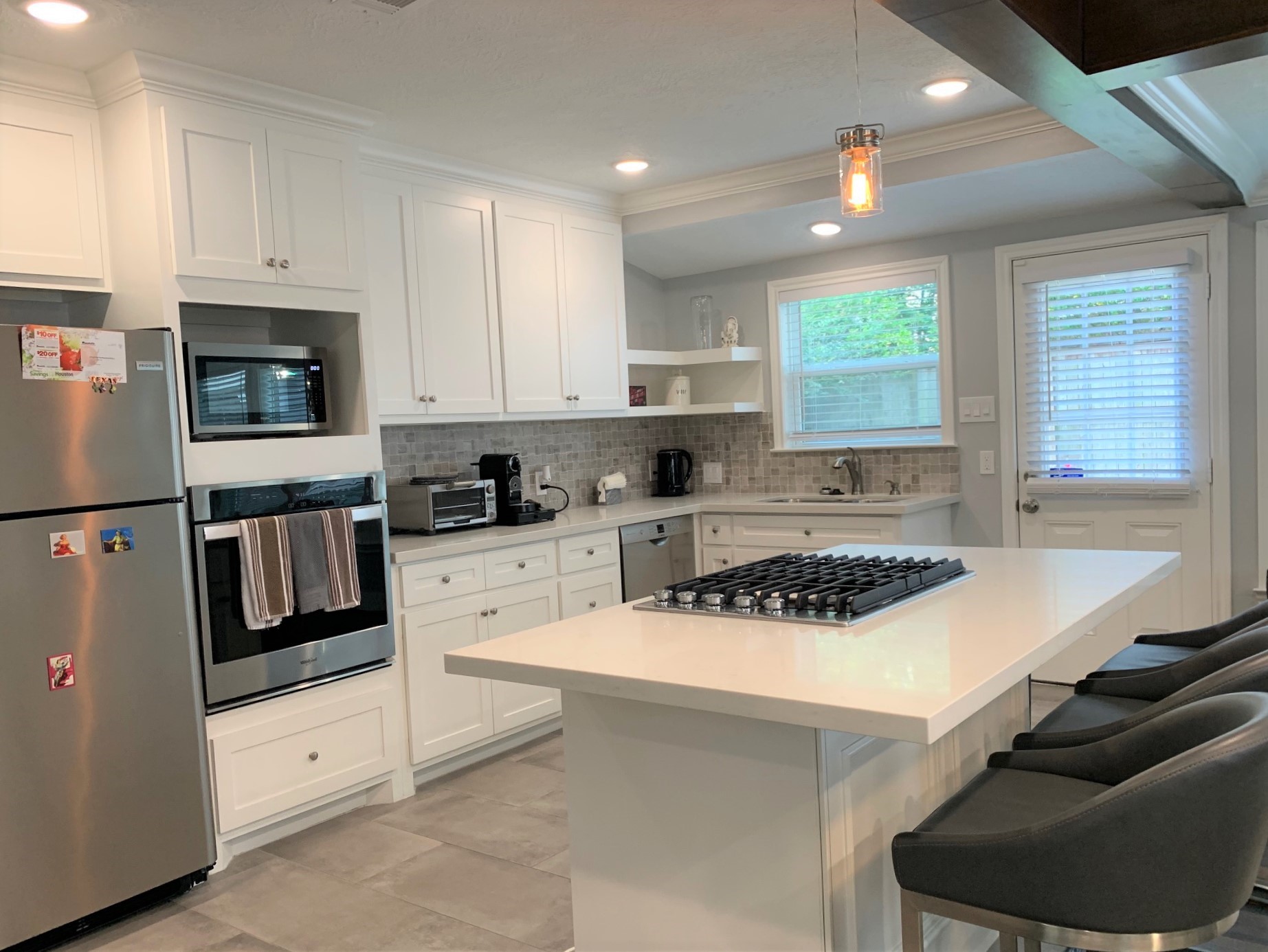 3909 Rice Boulevard Houston, TX 77005 - Photo 6 of 17 a kitchen with stainless steel appliances granite countertop a stove a sink and a refrigerator
