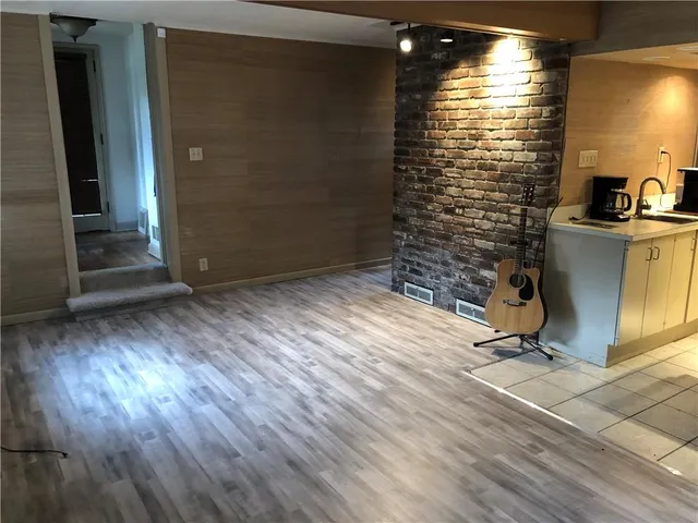 a view of a room with wooden floor and a window