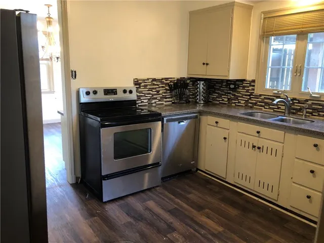 a kitchen with granite countertop a stove and a sink