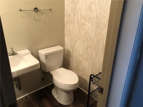 a white toilet sitting next to a shower curtain