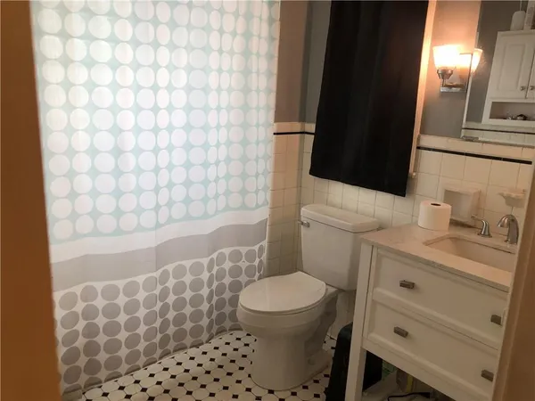 a bathroom with a toilet a sink and a shower