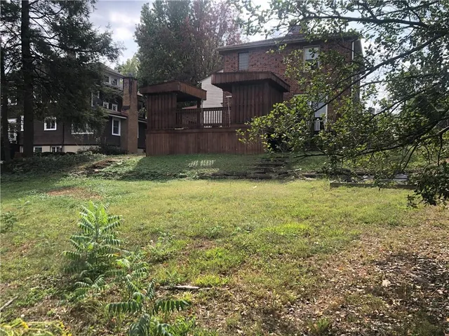 a view of a garden with a house