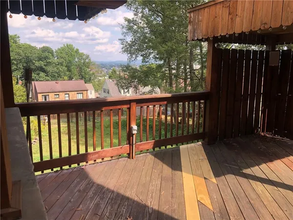a view of balcony with wooden floor