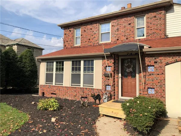 front view of a brick house with a large window