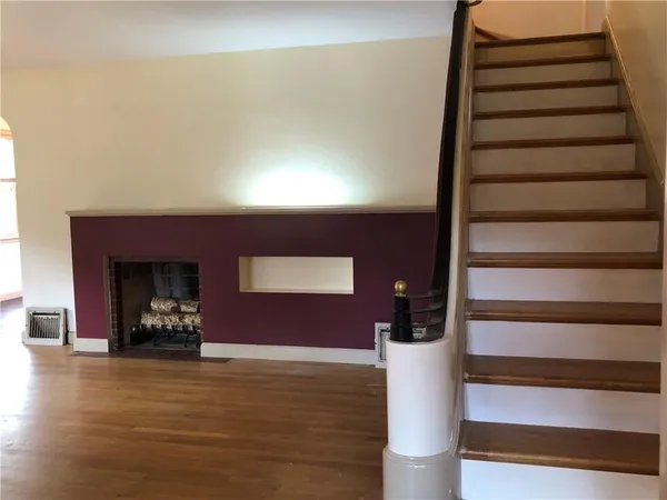 a view of entryway and hall with wooden floor