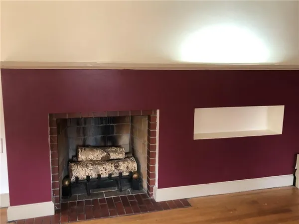 a room with wooden floor and furniture