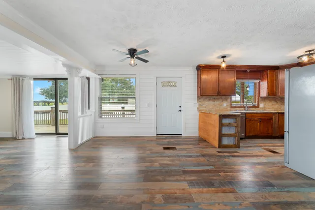 a view of kitchen with sink microwave refrigerator and cabinets