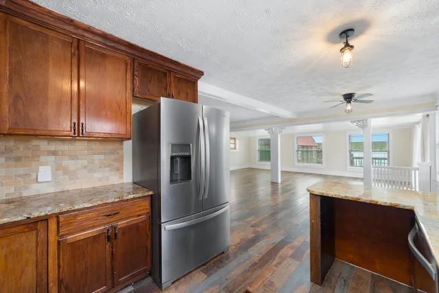 a kitchen with granite countertop stainless steel appliances and wooden cabinets