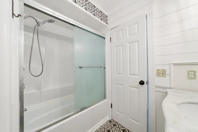 a bathroom with a shower and a shower