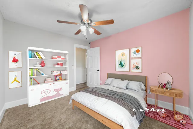 a bedroom with a bed a dresser and a window