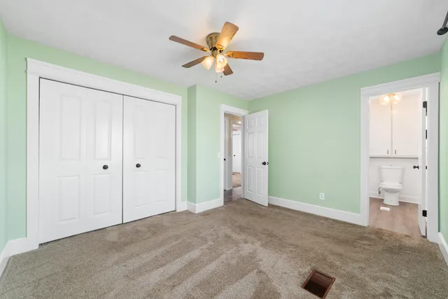 a view of a livingroom with a ceiling fan & a ceiling fan