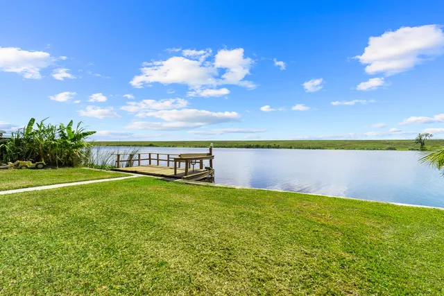 a view of a large swimming pool with an outdoor space and seating area