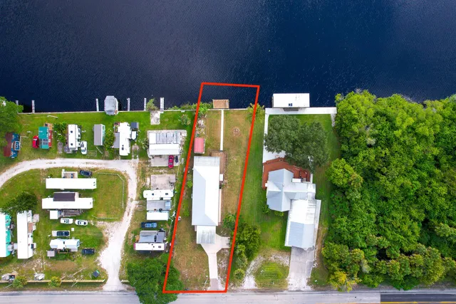 a view of house with outdoor space and a lake view