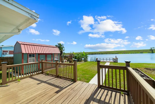 a view of a balcony with wooden floor