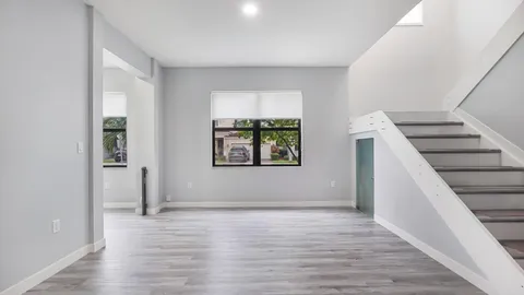 wooden floor in an empty room with a window
