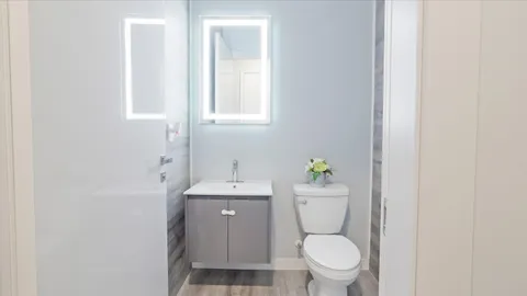 a white toilet sitting next to a bathroom sink