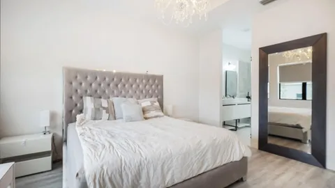 a bedroom with a bed and a lamp