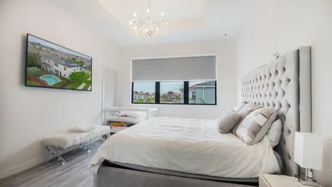 a bedroom with a bed and a painting on the wall