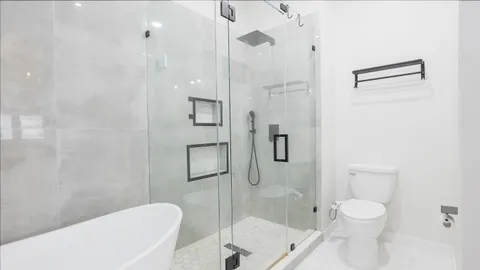 a bathroom with a toilet a sink and shower