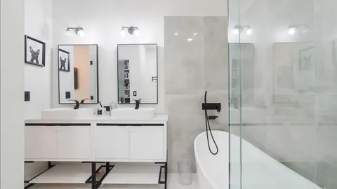 a bathroom with a double vanity sink a mirror and shower