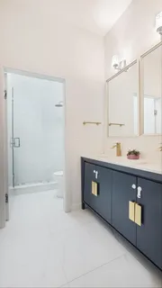 a bathroom with a tub a sink and mirror