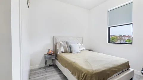 a bedroom with a bed and a painting on the wall