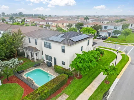 an aerial view of a house with a garden and lake view