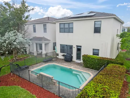 a view of a house with backyard and sitting area