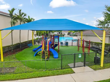 a view of a park with iron fence