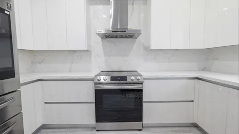 a kitchen with a stove and a refrigerator