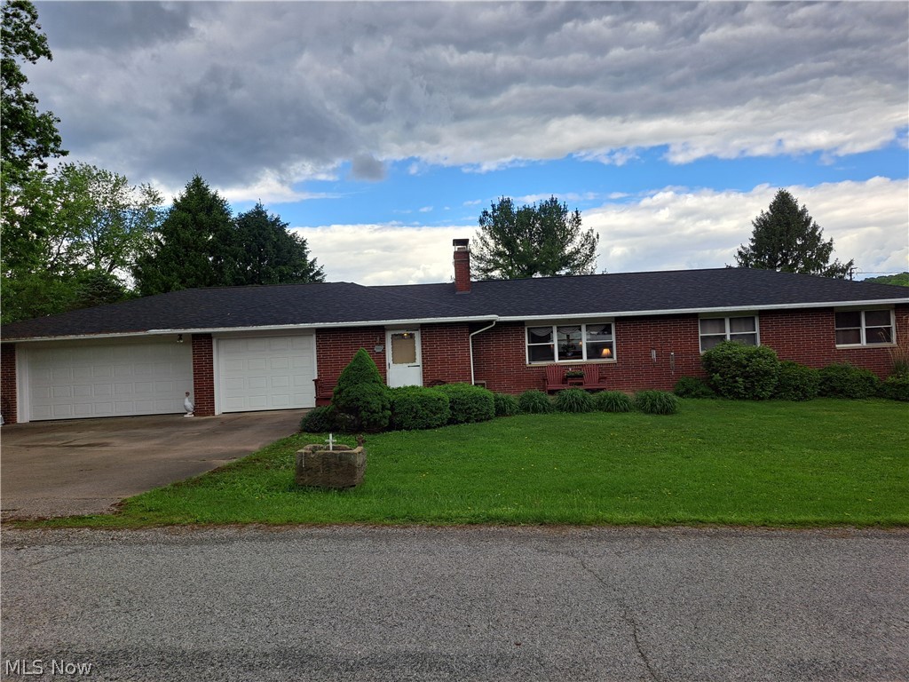 3905 Mark Road Cambridge, OH 43725 - Photo 2 of 50 Ranch-style house featuring a garage and a front lawn
