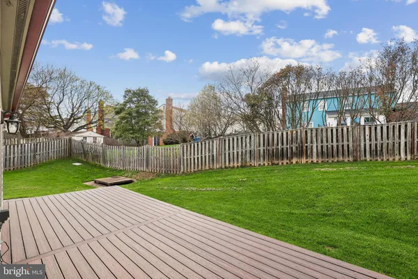 a view of a backyard with wooden fence