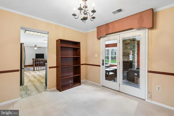 a view of kitchen with refrigerator and window