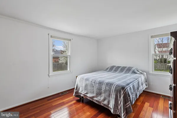 a bedroom with a bed next to a window