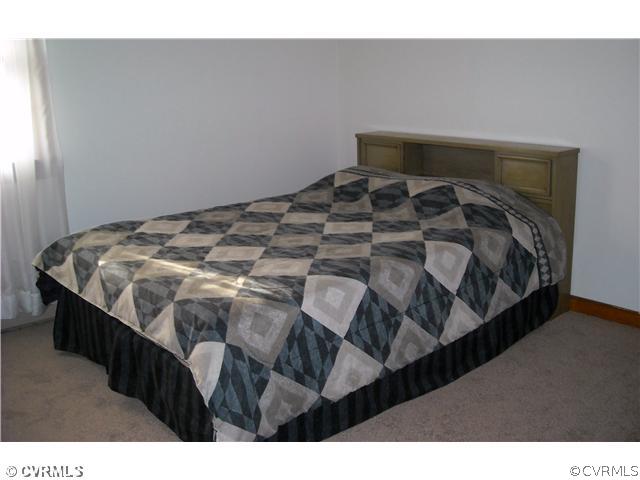 9531 Chester Road North Chesterfield, VA 23237 - Photo 8 of 12 a bed sitting in a bedroom next to a window