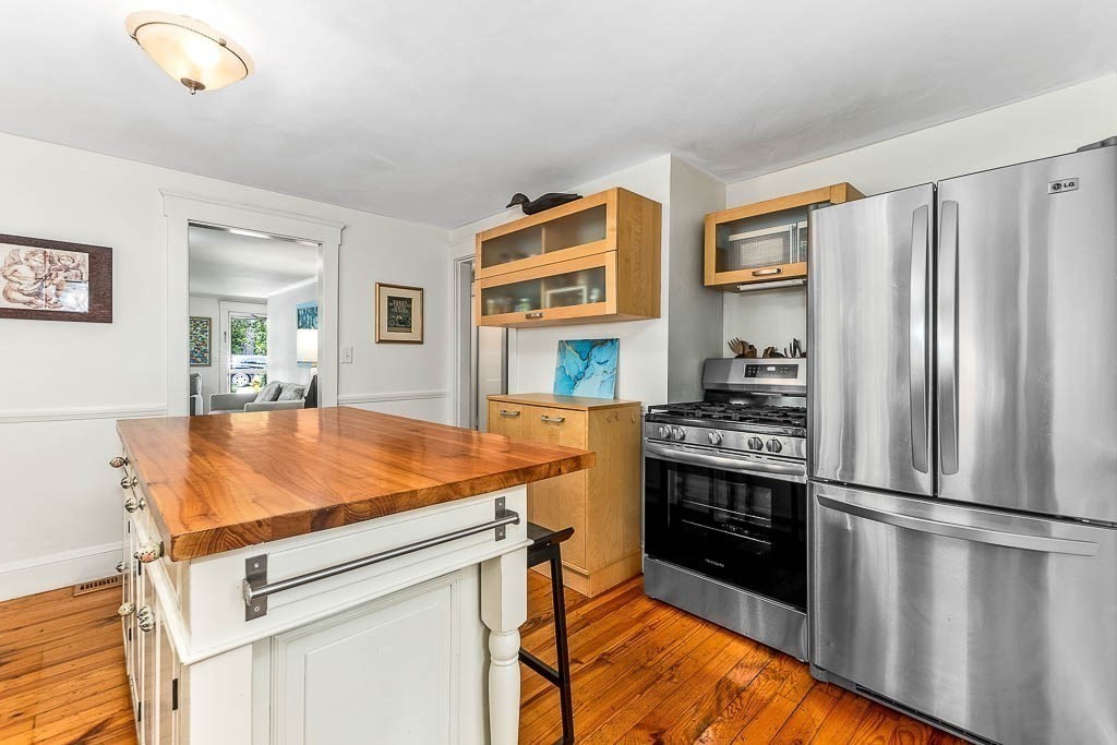 61 Crane Street Dedham, MA 02026 - Photo 14 of 42 a kitchen with stainless steel appliances granite countertop a refrigerator stove and sink