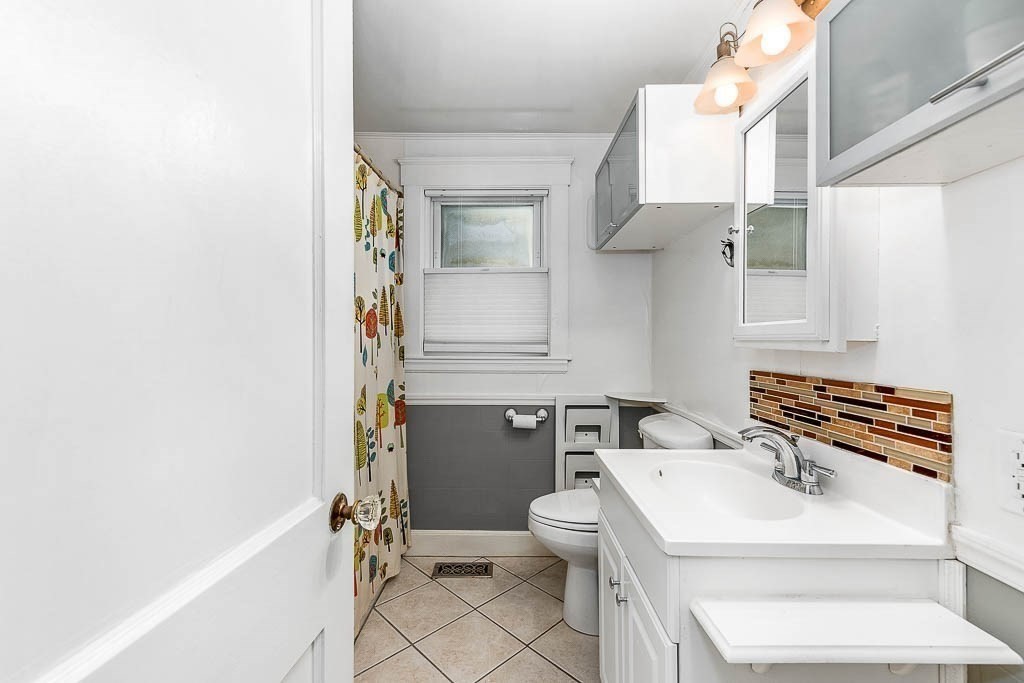 61 Crane Street Dedham, MA 02026 - Photo 20 of 42 a bathroom with a sink toilet and shower