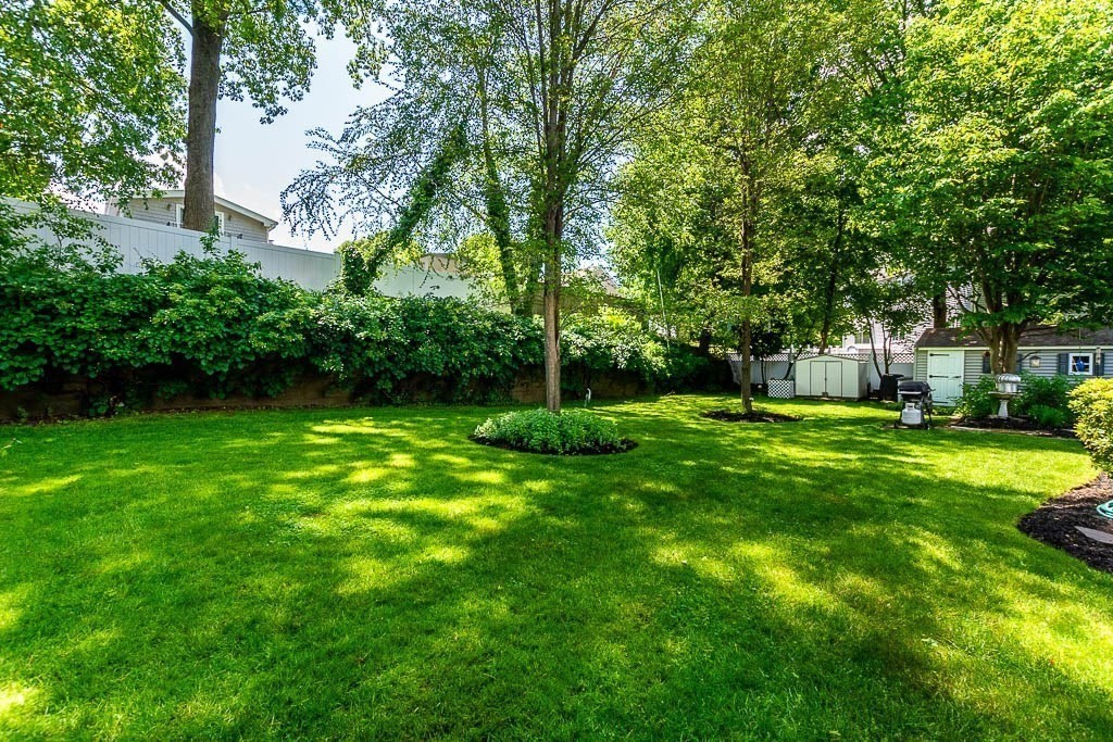 61 Crane Street Dedham, MA 02026 - Photo 30 of 42 a view of a house with a yard