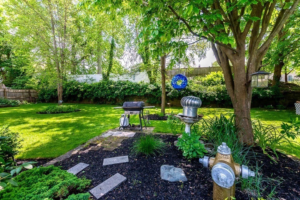 61 Crane Street Dedham, MA 02026 - Photo 32 of 42 a front view of a house with garden