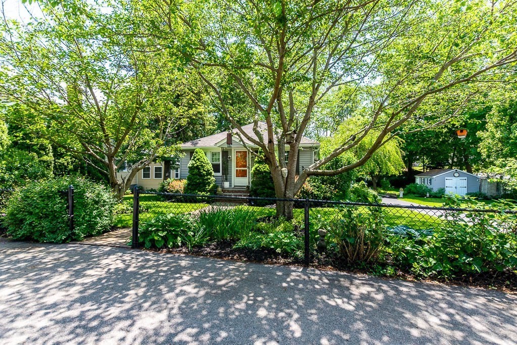 61 Crane Street Dedham, MA 02026 - Photo 4 of 42 a front view of a house with a yard