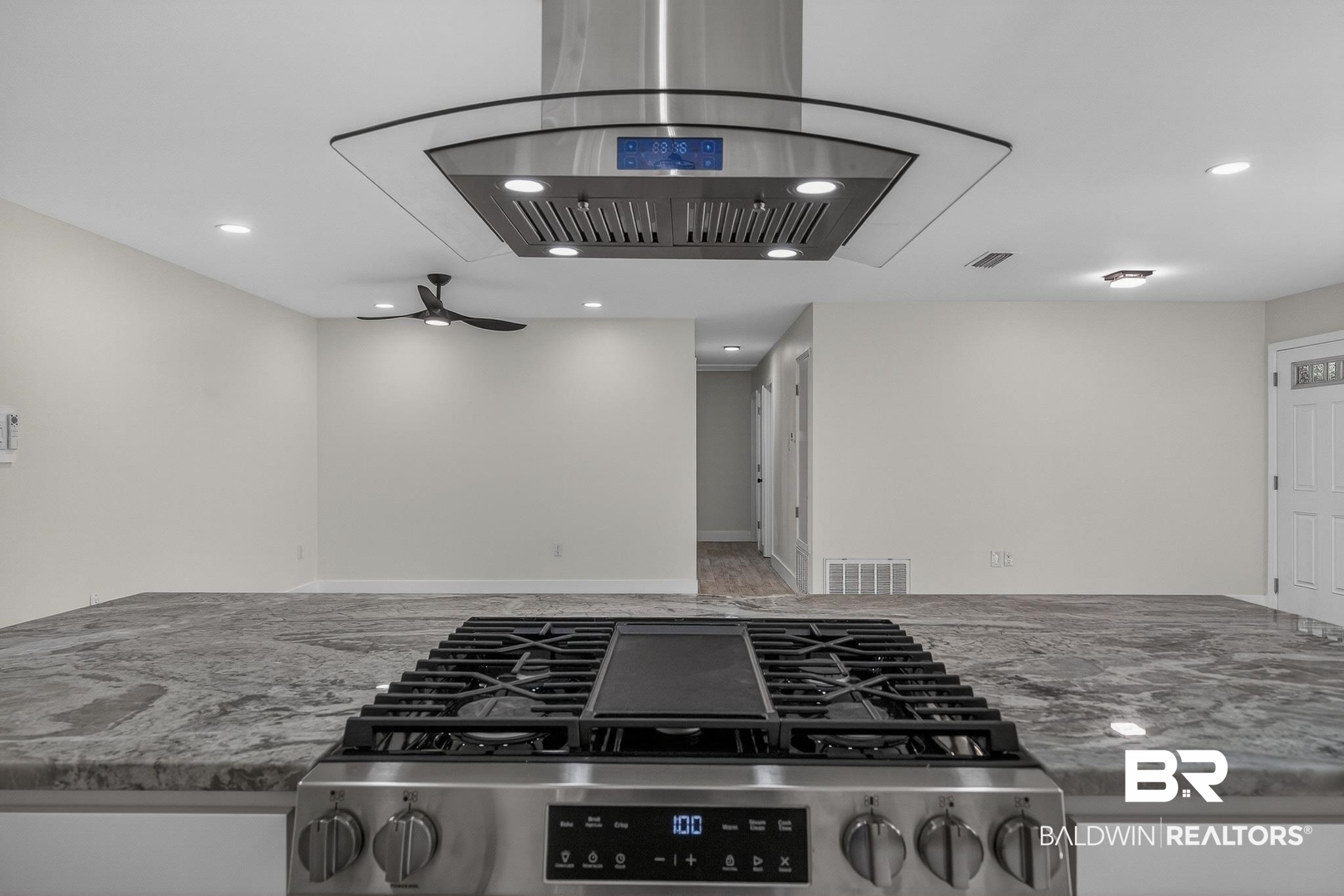 10650 Old Pascagoula Road Theodore, AL 36582 - Photo 24 of 77 Kitchen view of island exhaust hood, light stone counters, stainless steel range with gas stovetop, recessed lighting, and a ceiling fan