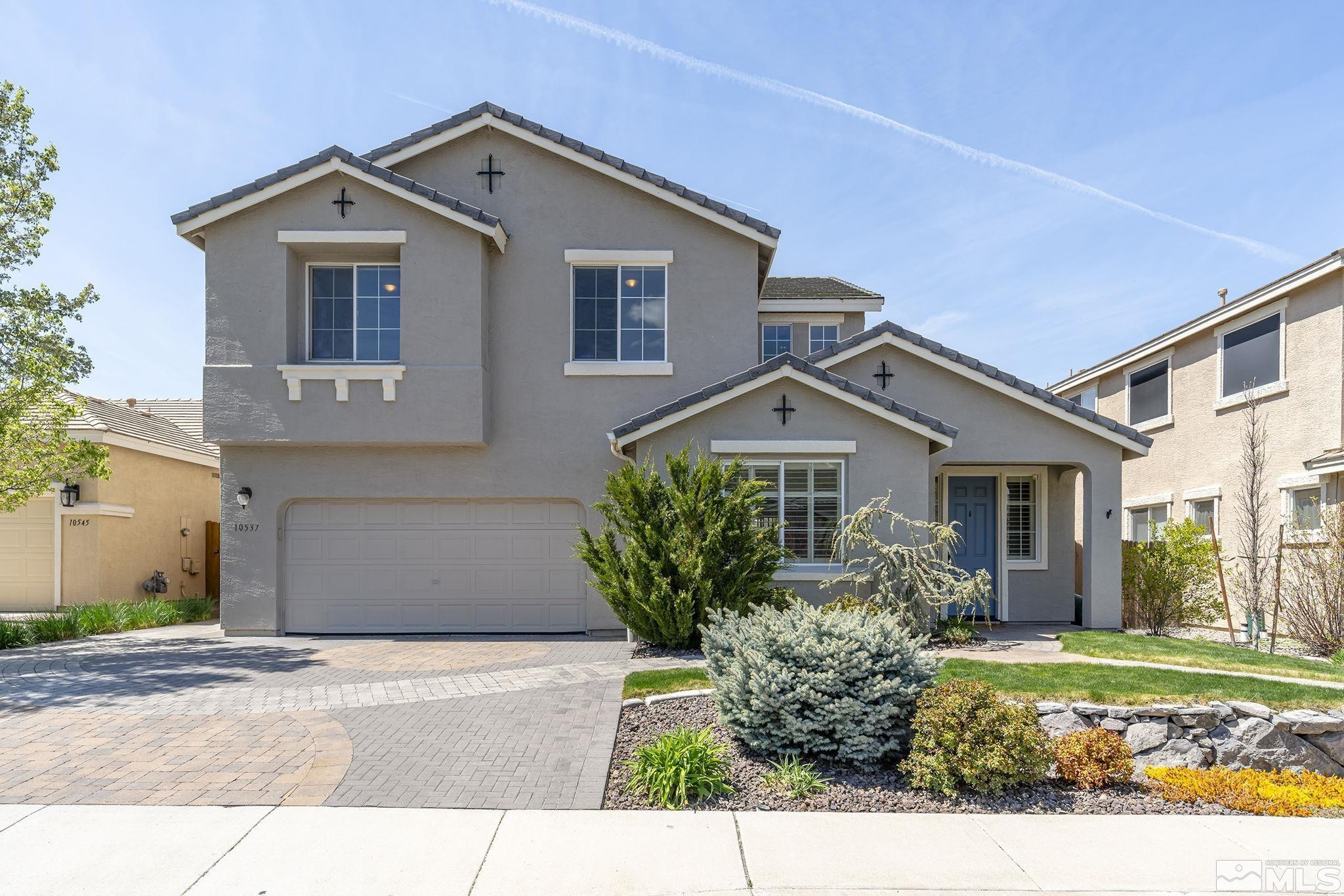10537 Fort Morgan Way Reno, NV 89521 - Photo 1 of 30 a front view of a house with garden