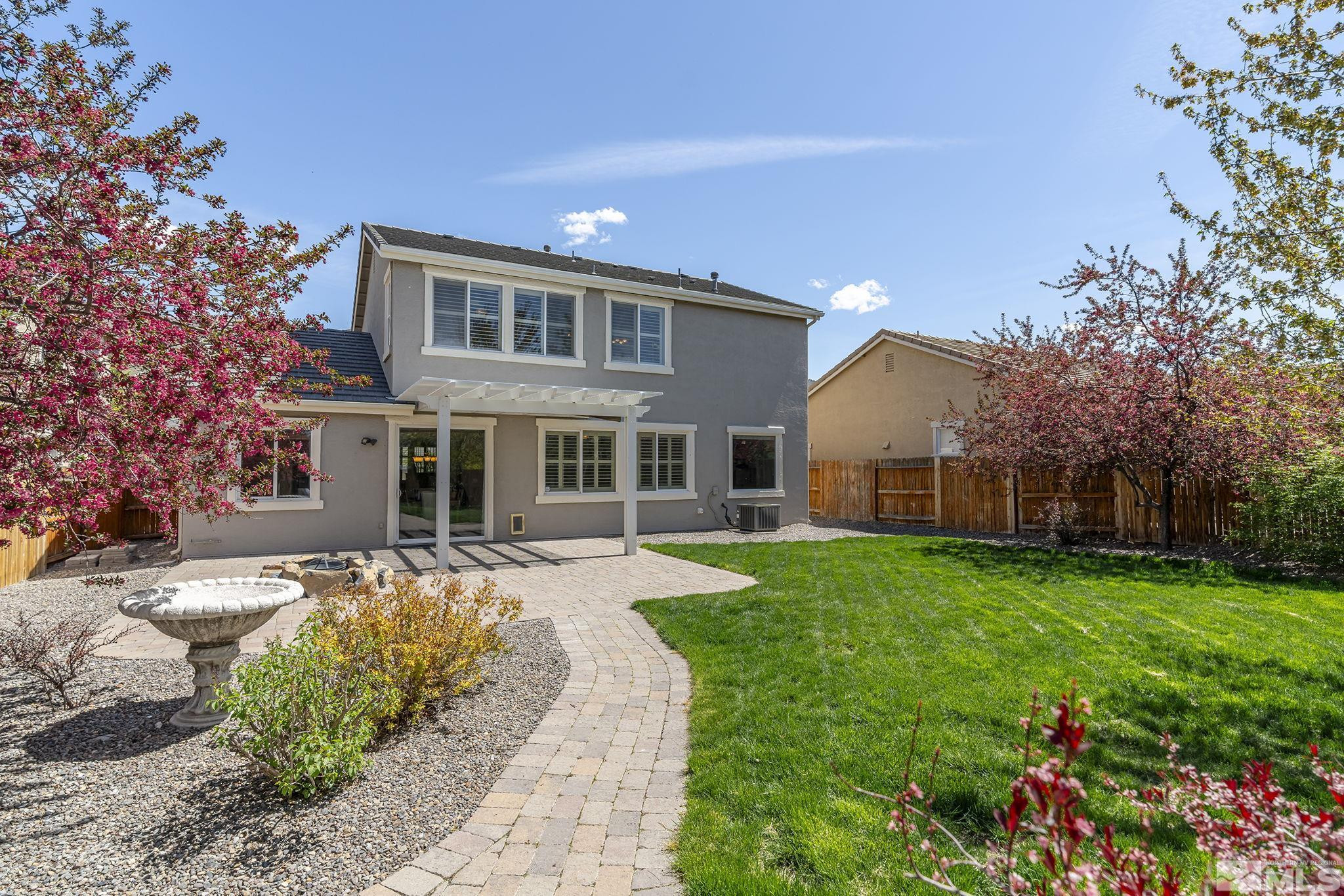 10537 Fort Morgan Way Reno, NV 89521 - Photo 26 of 30 a front view of a house with a yard and porch